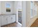 Mud Room featuring built-in cabinets, a countertop, and easy access to the backyard at 13540 Autumn Harvest Ave, Winter Garden, FL 34787