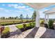 View from the porch showcasing the landscaping, walkway, and expansive green space of the surrounding community at 13540 Autumn Harvest Ave, Winter Garden, FL 34787