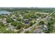 A high aerial view of a neighborhood and home with mature trees with lake and cityscape views at 1440 Roosevelt St, Orlando, FL 32804