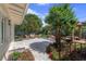 Picturesque backyard with stone patio, lounge seating, vibrant flowers, and lush greenery at 1440 Roosevelt St, Orlando, FL 32804
