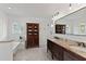 Renovated bathroom with double sinks, soaking tub, glass shower, and stylish cabinetry at 1440 Roosevelt St, Orlando, FL 32804