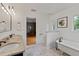Bright bathroom featuring double vanity, soaking tub, and tiled floors at 1440 Roosevelt St, Orlando, FL 32804
