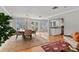 Open dining area with modern chandelier, hardwood floors, and an adjacent sitting area at 1440 Roosevelt St, Orlando, FL 32804