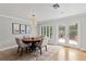 Bright dining area with modern lighting fixture, decorative wall art, and view to the backyard at 1440 Roosevelt St, Orlando, FL 32804