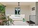 Welcoming front porch featuring a white bench, elegant lighting, and stylish black railings at 1440 Roosevelt St, Orlando, FL 32804