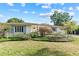 Charming single-story home featuring blue shutters and a beautifully landscaped front yard at 1440 Roosevelt St, Orlando, FL 32804