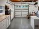 Spacious garage with workbench, storage cabinets, and room for multiple vehicles at 1440 Roosevelt St, Orlando, FL 32804