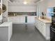 Spacious kitchen with white cabinetry, tile backsplash, ample counter space, and modern appliances at 1440 Roosevelt St, Orlando, FL 32804