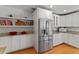 Spacious kitchen with stainless steel appliances, open shelves, and modern cabinetry at 1440 Roosevelt St, Orlando, FL 32804