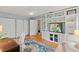 Sitting room features wood floors, built-in shelving, a ceiling fan, and is filled with natural light from large windows at 1440 Roosevelt St, Orlando, FL 32804