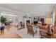 Bright living room with hardwood floors, stylish fireplace, and views into the dining area at 1440 Roosevelt St, Orlando, FL 32804