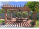 Backyard pergola over a brick patio, furnished with a table and chairs, creating a charming outdoor space at 1440 Roosevelt St, Orlando, FL 32804