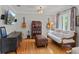 Cozy sitting room with hardwood floors, sofa, and guitars, providing a relaxing atmosphere at 1440 Roosevelt St, Orlando, FL 32804
