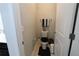 Half-bath featuring a dark-colored toilet seat, neutral walls, and a towel rack at 146 Loblolly Ln, Davenport, FL 33837