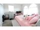 Bright bedroom with plush pink bedding, arched windows, and a cozy, inviting atmosphere at 146 Loblolly Ln, Davenport, FL 33837