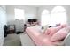Bright bedroom with plush pink bedding, arched windows, and a cozy, inviting atmosphere at 146 Loblolly Ln, Davenport, FL 33837