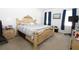 Bedroom features a large bed frame, neutral carpeting and walls, and black-out curtains at 146 Loblolly Ln, Davenport, FL 33837