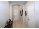 Inviting home entryway with tile flooring, an arched doorway, and neutral wall colors at 146 Loblolly Ln, Davenport, FL 33837