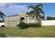 Beautiful single-story home features well-manicured lawn, two-car garage, and charming architectural details at 146 Loblolly Ln, Davenport, FL 33837