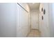 Neutral-toned hallway showcasing closet space and a separate entrance, offering practical storage solutions at 146 Loblolly Ln, Davenport, FL 33837