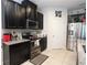 Modern kitchen features dark cabinetry, stainless steel appliances, and ample countertop space at 146 Loblolly Ln, Davenport, FL 33837