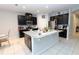 Modern kitchen featuring a center island, black cabinetry, and stainless steel appliances at 146 Loblolly Ln, Davenport, FL 33837