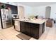Modern kitchen with stainless steel appliances, granite countertops, and a large center island at 146 Loblolly Ln, Davenport, FL 33837