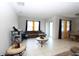 Bright living room with tile floors and large windows offering natural light and openness at 146 Loblolly Ln, Davenport, FL 33837
