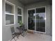 A covered patio with table, chairs, and sliding glass doors offers a relaxing outdoor space at 146 Loblolly Ln, Davenport, FL 33837