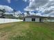 View of a large backyard with a white privacy fence and lush lawn at 1476 11Th Ave, Deland, FL 32724