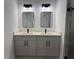 Bathroom featuring double vanity with framed mirrors, modern lights, and light countertops at 1476 11Th Ave, Deland, FL 32724