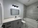 Bathroom with gray vanity, tub, and modern black fixtures at 1476 11Th Ave, Deland, FL 32724