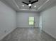 Bedroom featuring a ceiling fan, window, and tile flooring at 1476 11Th Ave, Deland, FL 32724