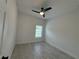 Bright bedroom features neutral paint, tile flooring, and ceiling fan at 1476 11Th Ave, Deland, FL 32724