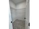 Walk-in closet with wire shelving and tile flooring at 1476 11Th Ave, Deland, FL 32724