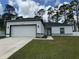 Charming one-story home featuring a 2-car garage, well-maintained lawn, and modern exterior finishes at 1476 11Th Ave, Deland, FL 32724