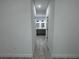Hallway with tile flooring leading to a bathroom with double vanity at 1476 11Th Ave, Deland, FL 32724