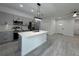 Updated kitchen showcasing an island, stainless steel appliances and a view of the front entry at 1476 11Th Ave, Deland, FL 32724