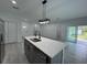 Kitchen with an island featuring a double sink, stainless steel appliances, and an open layout at 1476 11Th Ave, Deland, FL 32724