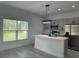 Modern kitchen featuring a large island with seating, stainless steel appliances, and natural light at 1476 11Th Ave, Deland, FL 32724