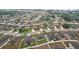 An aerial view showing well-maintained homes with manicured lawns in a quiet neighborhood with mature trees at 1846 Galloway Ter, Winter Haven, FL 33881