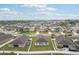 An aerial view of a residential neighborhood with similar styled homes on well maintained lawns under a blue sky at 1846 Galloway Ter, Winter Haven, FL 33881