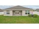 The back exterior features a covered patio and well-maintained lawn at 1846 Galloway Ter, Winter Haven, FL 33881