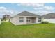 Back exterior of the home with a green lawn and great sun exposure at 1846 Galloway Ter, Winter Haven, FL 33881