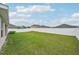 A backyard enclosed by a white vinyl fence and featuring a grassy area at 1846 Galloway Ter, Winter Haven, FL 33881