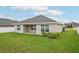 Home exterior featuring a well-maintained lawn, a patio, and an AC unit at 1846 Galloway Ter, Winter Haven, FL 33881