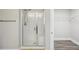 A bathroom containing a glass shower door and a door that leads to a closet space at 1846 Galloway Ter, Winter Haven, FL 33881