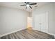 Neutral bedroom with a ceiling fan, wood-look floors, and double closet at 1846 Galloway Ter, Winter Haven, FL 33881
