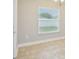 Bright bedroom featuring tile flooring, a large window with blinds, and neutral wall paint at 1846 Galloway Ter, Winter Haven, FL 33881