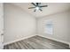 Neutral bedroom with a ceiling fan, wood-look floors and a window at 1846 Galloway Ter, Winter Haven, FL 33881